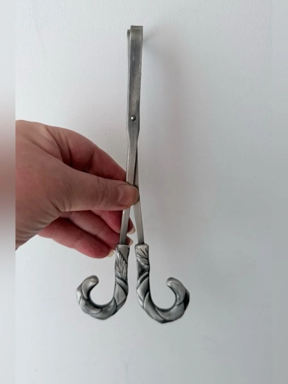 vintage pewter wick trimmer featuring a detailed repoussé leaf design